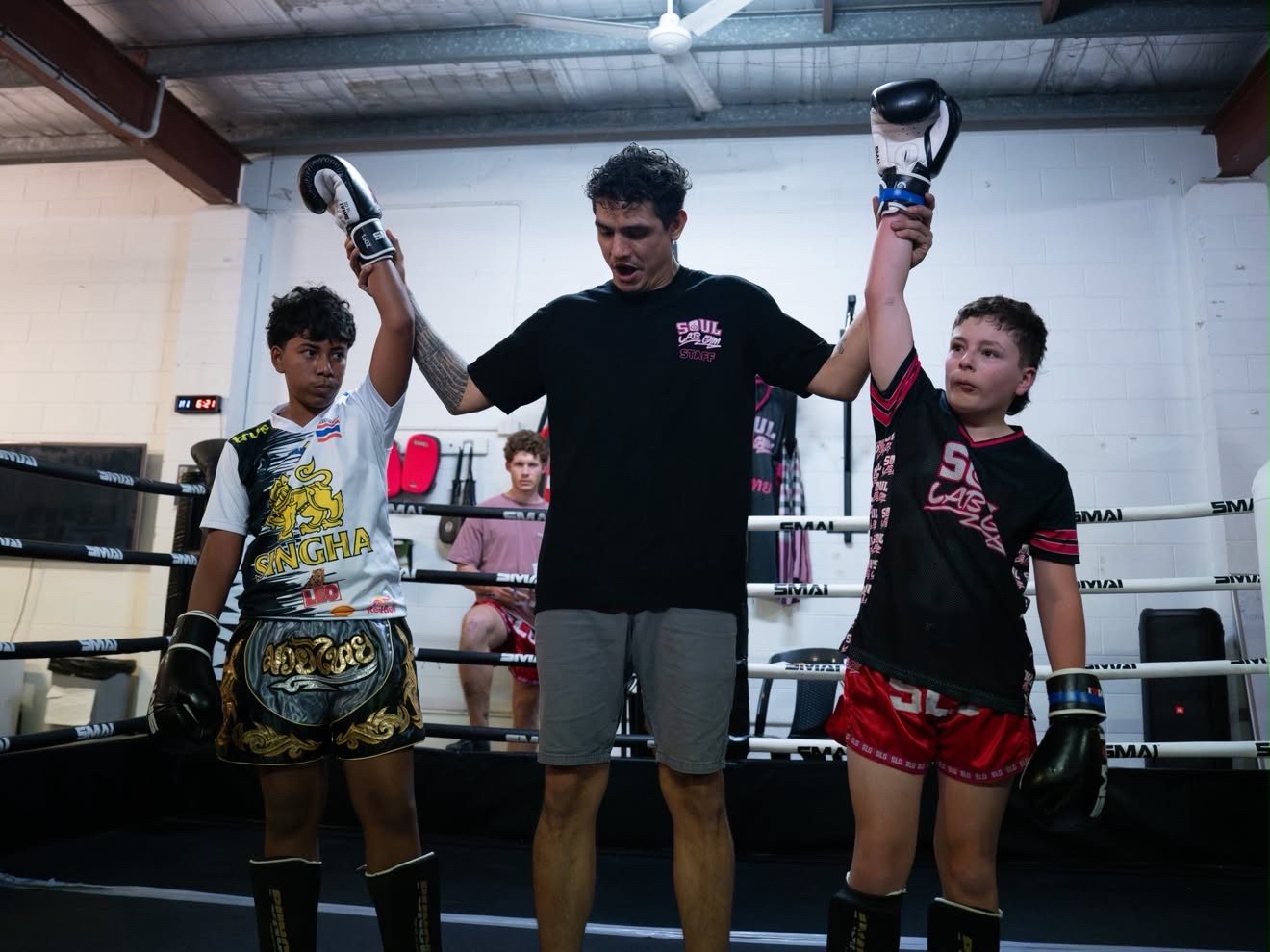 Junior fighters with hands raised by the referee at Battle at the Lab