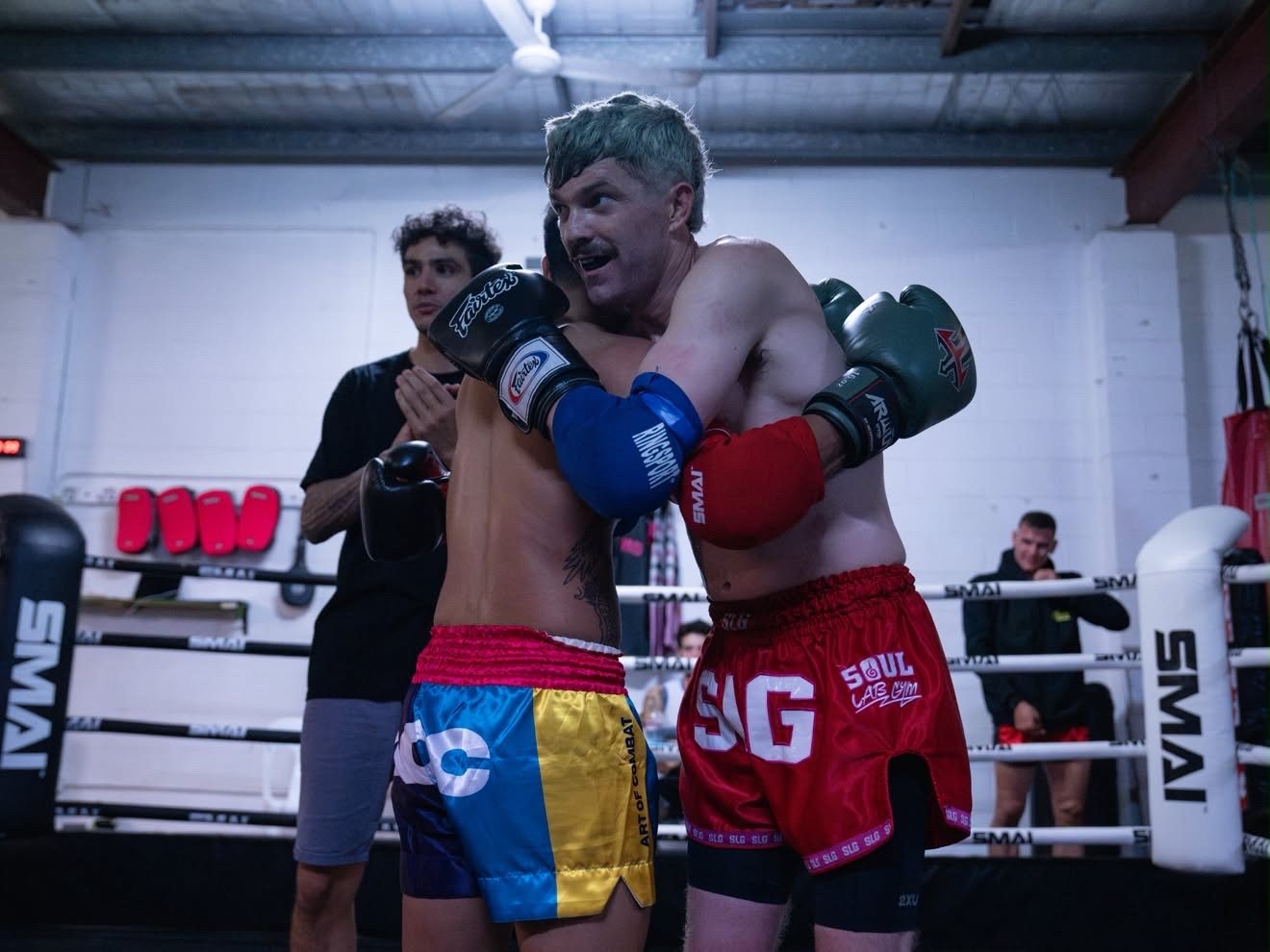 Two fighters embracing after their bout at Battle at the Lab