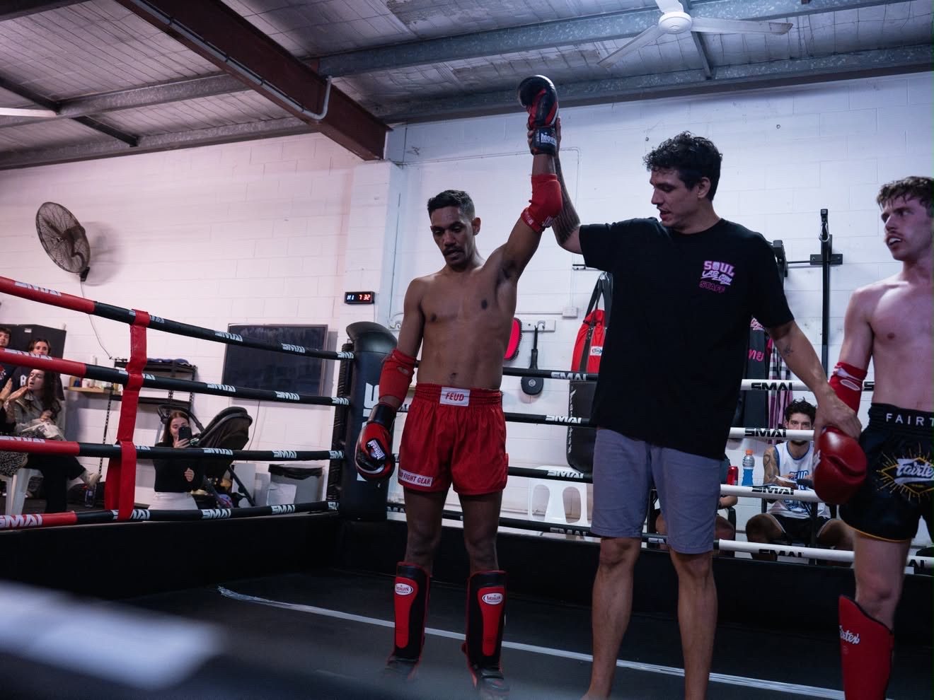 Referee raising the winner's hand at Battle at the Lab