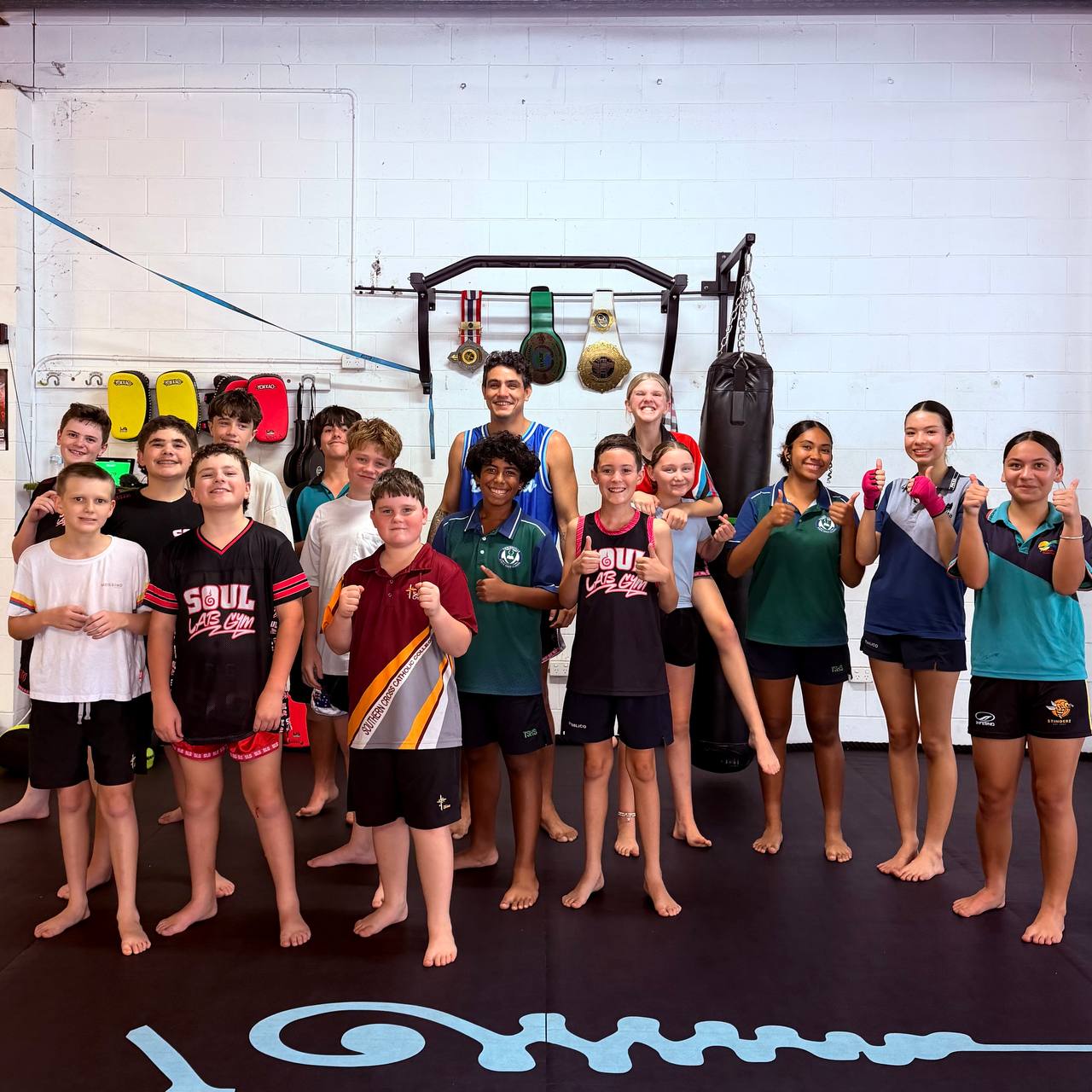 Kids with coach thumbs up
