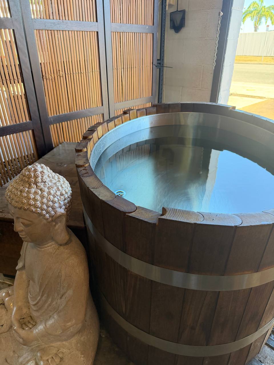 Tilted angle of ice bath with Buddha statue