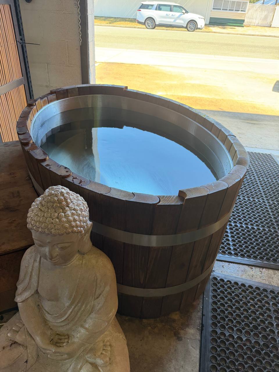 Ice bath with peaceful Buddha statue beside it